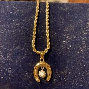 10k gold horseshoe with 1/2 carat floating diamond pendant